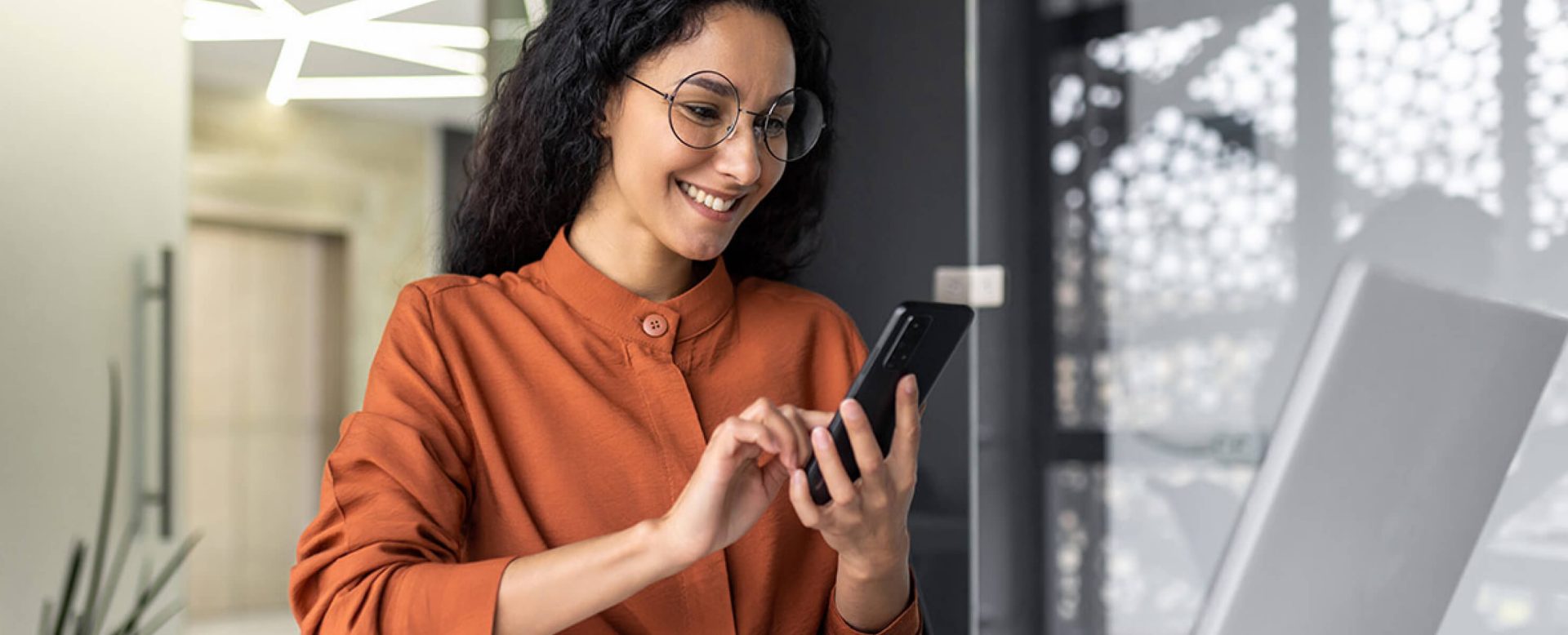 Professionals, welcome: a young woman, representative of young professionals, checking news on her smartphone