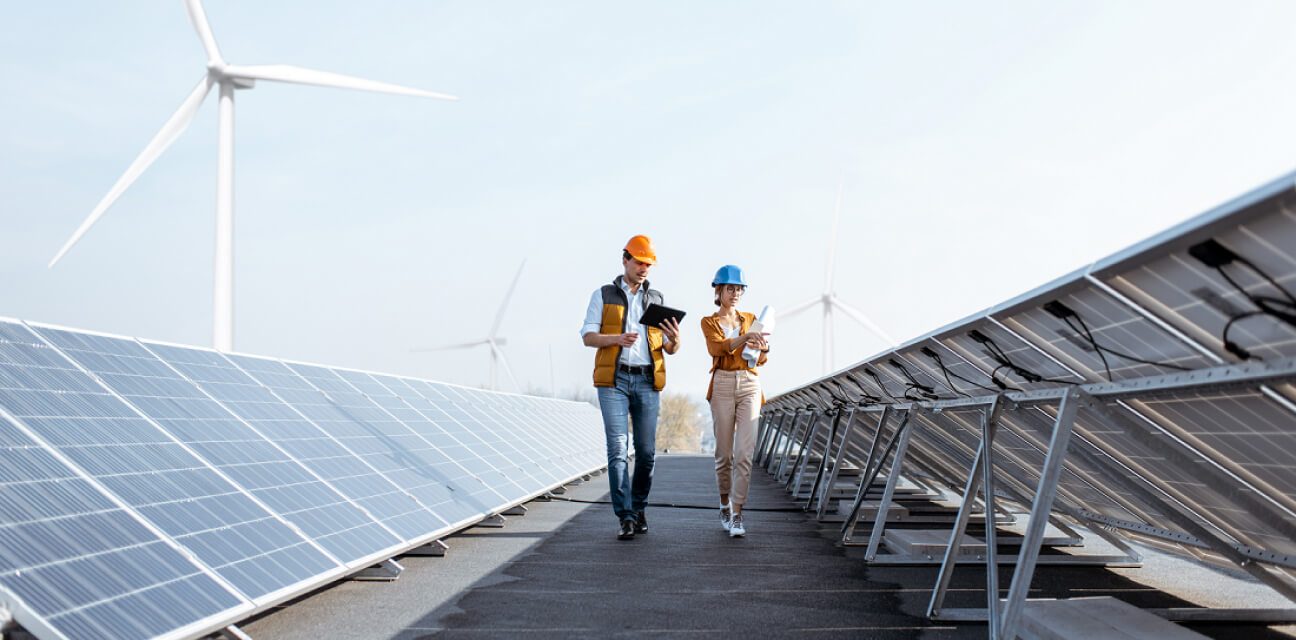 DZ BANK sees supporting companies on their way to more sustainability as one of our responsibilities, such as here: two engineers checking up on a wind and solar farm