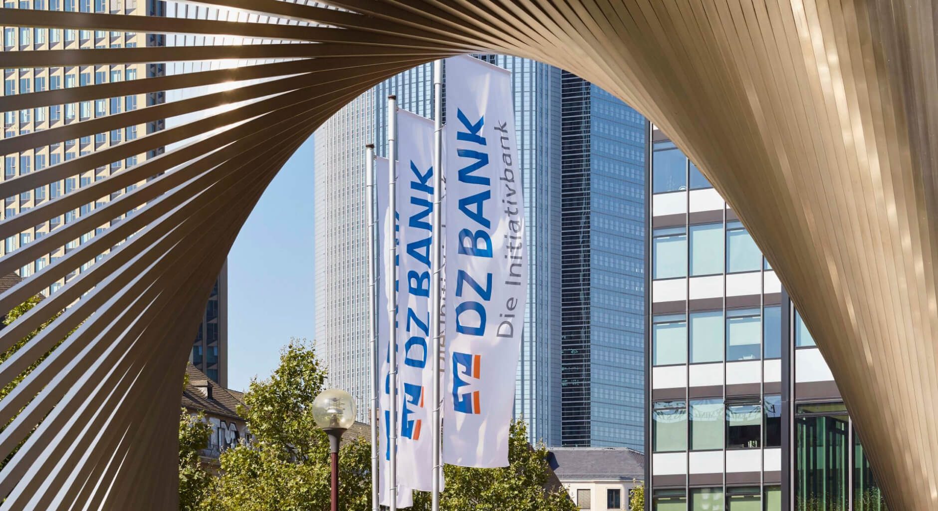 DZ BANK flags, as seen through the sculpture “Die Welt” (“The world”) in front of the DZ BANK Kunststiftung and DZ Privatbank building in Frankfurt